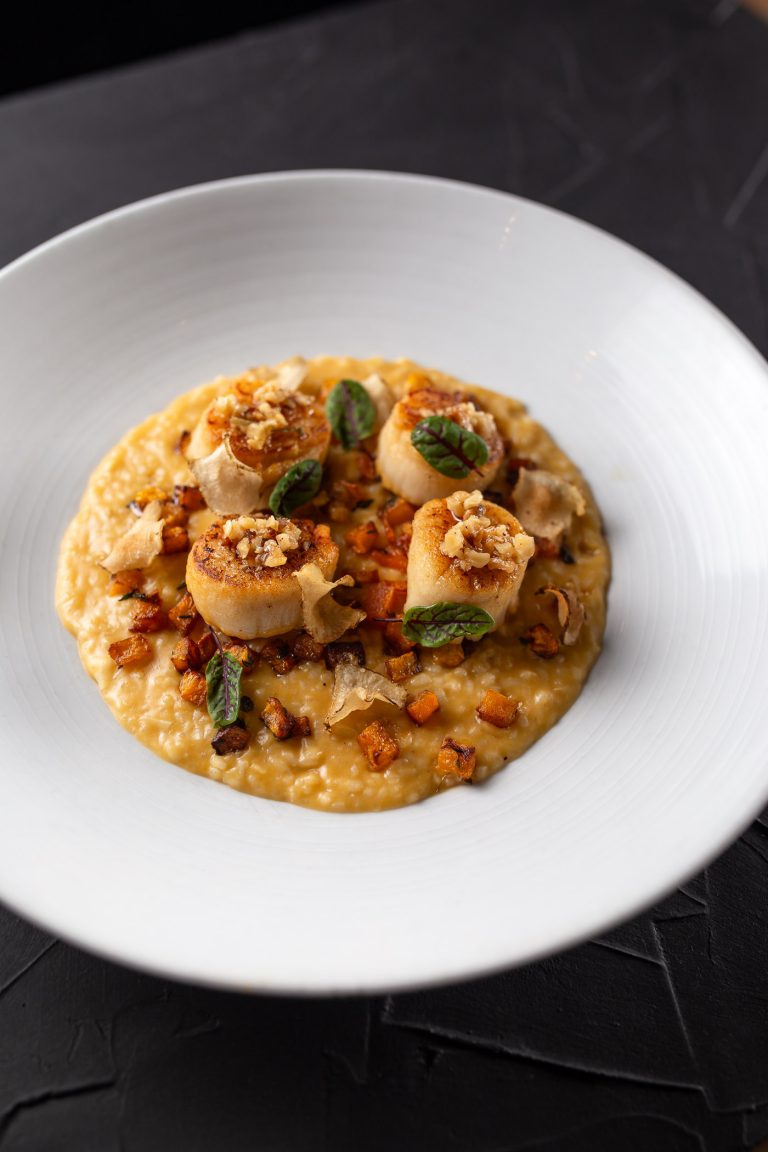 Fall seasonal seared scallop entree on a plate