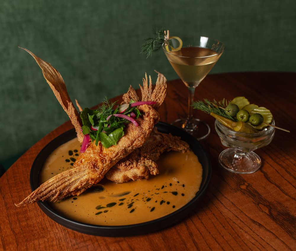 Table with Fried Red Snapper Collar and a martini